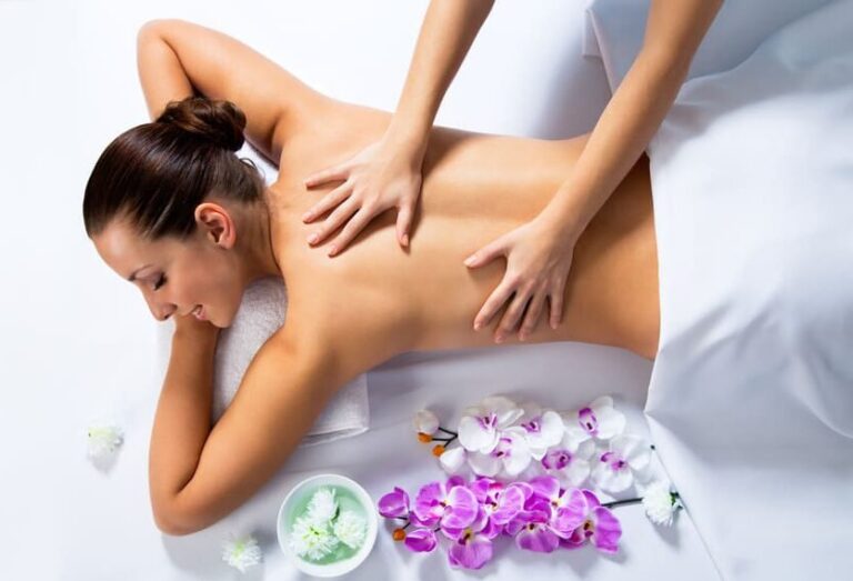 Ganzkörpermassage auf einer Liege mit Orchideen